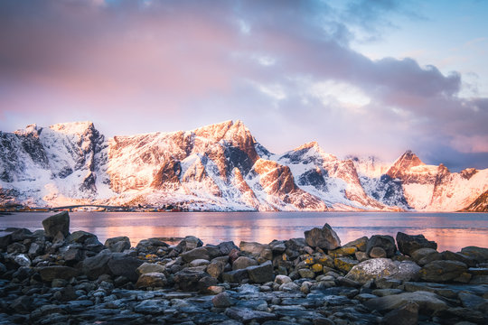 Mountain Landscape covered with snow in Lofoten, Norway at sunrise.