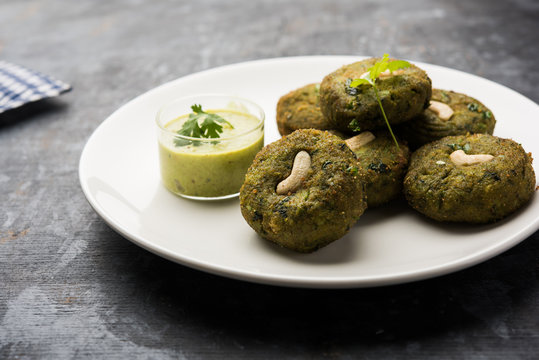 Hara bhara Kabab or Kebab is Indian vegetarian snack recipe served with green mint chutney over moody background. selective focus