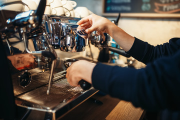Barista hand pours beverage from coffee machine
