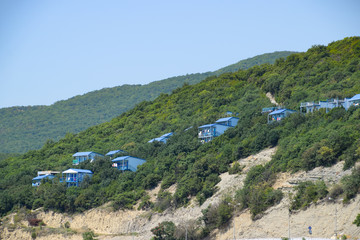 Fototapeta na wymiar Houses on the mountain for tourists. A house among the trees.