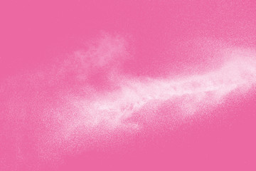 White powder explosion  on pink background.