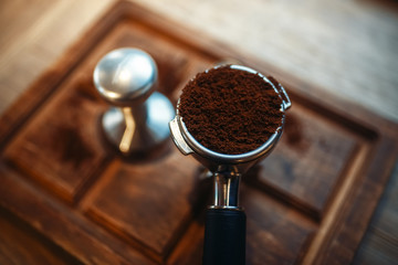 Turk with fresh ground coffee on wooden counter