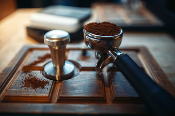 Turk with fresh ground coffee on wooden counter