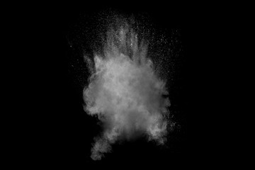 Bizarre forms of white powder explosion cloud against black background.