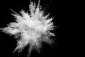 Bizarre forms of white powder explosion cloud against black background.