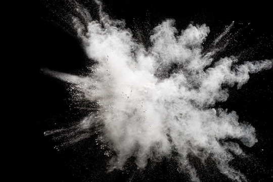 Bizarre forms of white powder explosion cloud against black background.