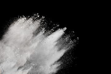 Bizarre forms of white powder explosion cloud against black background.