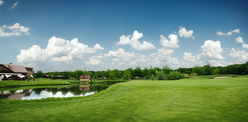 Green field and lake for golfing, golf course