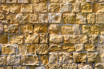 Old yellow brick stone wall.