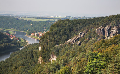 Fototapeta na wymiar Elbe river and Bastei at Elbe sandstone mountains near Rathen village. Saxon Switzerland National Park. Germany