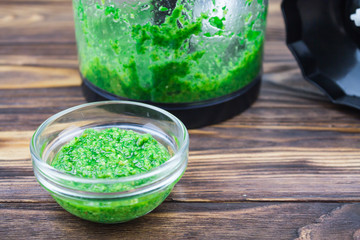 Pesto sauce made from basil on a wooden background
