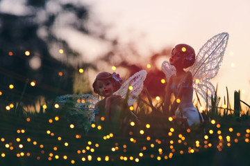 image of magical little fairy in the forest at sunset.