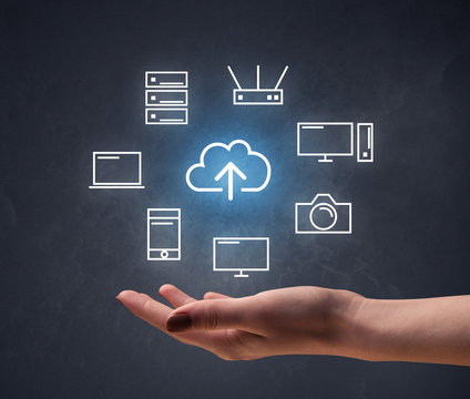 Cloud and computing related icons hovering over young hand 