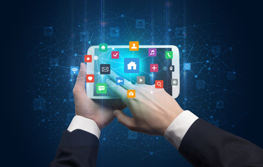 Hand using tablet with colorful bounce application symbols and icons concept
