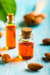 oil almond cosmetic medicine health nature glass vial wooden background
