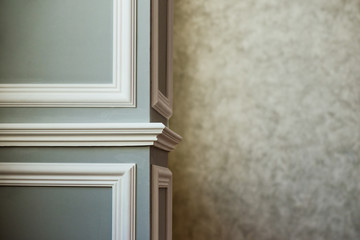 Gray column with white molding. Texturized grey putty. Vintage or grungy background of venetian stucco texture as pattern wall.