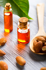 oil almond cosmetic medicine health nature glass vial wooden background
