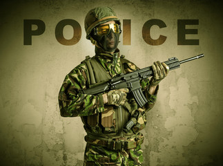 Uniformed armed soldier with damaged wall background
