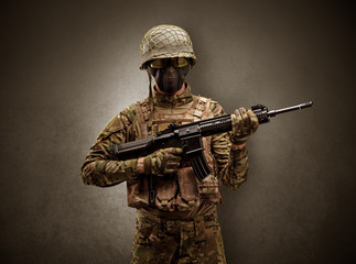 Soldier agent in a dark room with arms on his hand and gas mask
