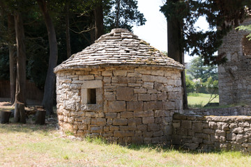 Brijuni, Croatia - July 28, 2018: View of a round stone hut on the island of Brijuni, Croatia. It served as a shelter in bad weather, a love nest and a storeroom.