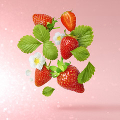 Flying Fresh tasty ripe strawberry with green leaves