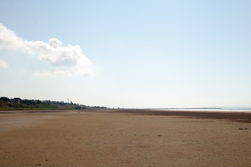 Drying up estuary with healing mud and red algae at sunset