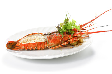 Grilled Lobster with salt, pepper, boiled potatoes and fresh vegetables on white round dish, Isolated on white background with shadow, low angle side view, Macro Close up Focus at the front of food.