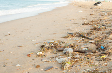 Garbage, bottles on the sea sandy shore