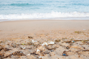Garbage, bottles on the sea sandy shore
