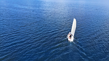 Aerial. Sailing of yacht by the sea background.