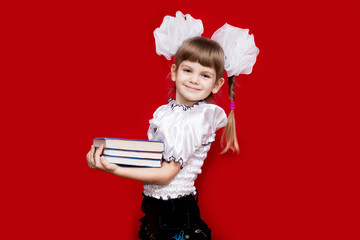 Little girl hold many books isolated on red. Concept of knowledge or school. Book lover
