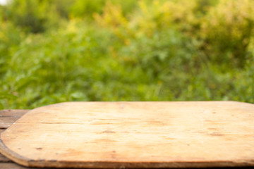Autumn garden background, wooden table for product placement, selective focus