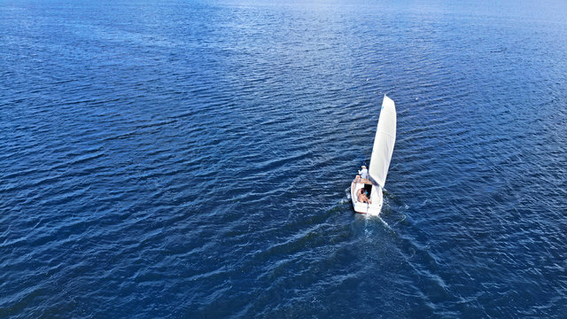 Aerial. Sailing of yacht by the sea background.