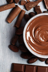 Melting chocolate  or melted chocolate with a chocolate swirl. Many stack and chips with powder.