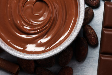 Melting chocolate  or melted chocolate with a chocolate swirl. Many stack and chips with powder.