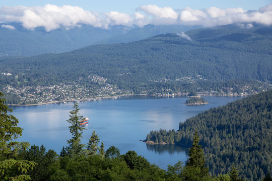 Aerial panoramic view of Belcarra and Deep Cove during a cloudy summer day. Taken from the top of Burnaby Mountain, Vancouver, BC, Canada.