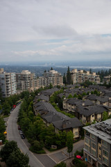 Naklejka na ściany i meble Aerial view of residential homes and buildings on top of Burnaby Mountain. Taken in Vancouver, British Columbia, Canada.