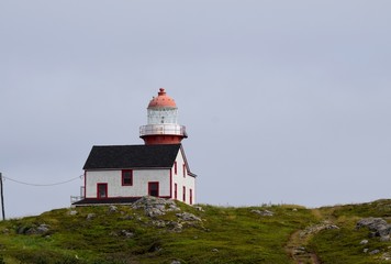Fototapeta na wymiar landscape around the Irish Loop; red and white lighthouse at Ferryland Head, Avalon Peninsula Newfoundland Canada 