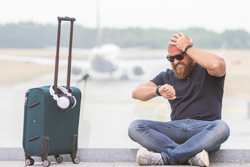 Young man is upset, angry and disappointed because of a canceled flight -  concept of a man...