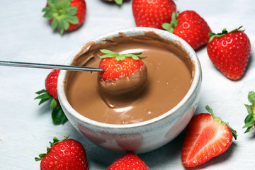 Fondue with Melting chocolate or melted chocolate and strawberry.