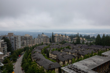 Fototapeta na wymiar Aerial view of residential homes and buildings on top of Burnaby Mountain. Taken in Vancouver, British Columbia, Canada.