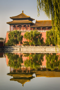 The Meridian or South Gate Watchtower of the Forbidden City in Beijing, China, with a reflection in the moat