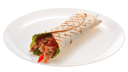 The Shawarma on the plate is isolated on a white background.