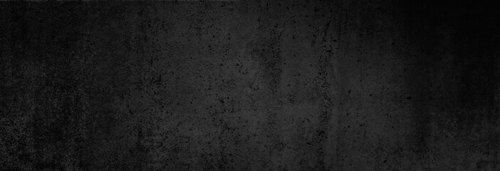 Beton-Textur in fast schwarz in XXL-Größe als Hintergrund, auf die Betonwand fällt ganz leichtes Licht - 217480034