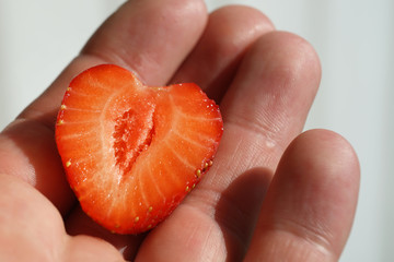 A half a strawberry on hand.