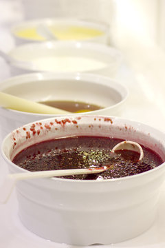 Open buffet at the hotel. Raspberry jam on white bowl with spoon