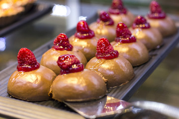 Turkish dessert, cake in sweet syrup with fresh raspberries