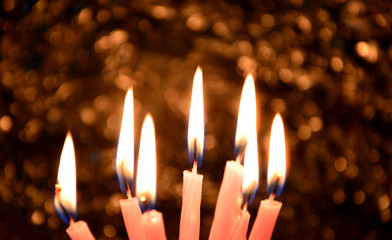 A lot of Birthday candles light with Bohke background in the dark room.