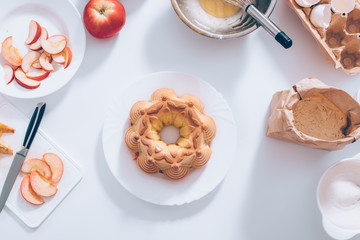 Traditional apple pie near ingredients and utensils