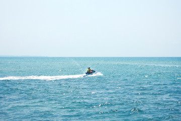 Fototapeta na wymiar Two men on a water jet scooter in the Mediterranean Sea